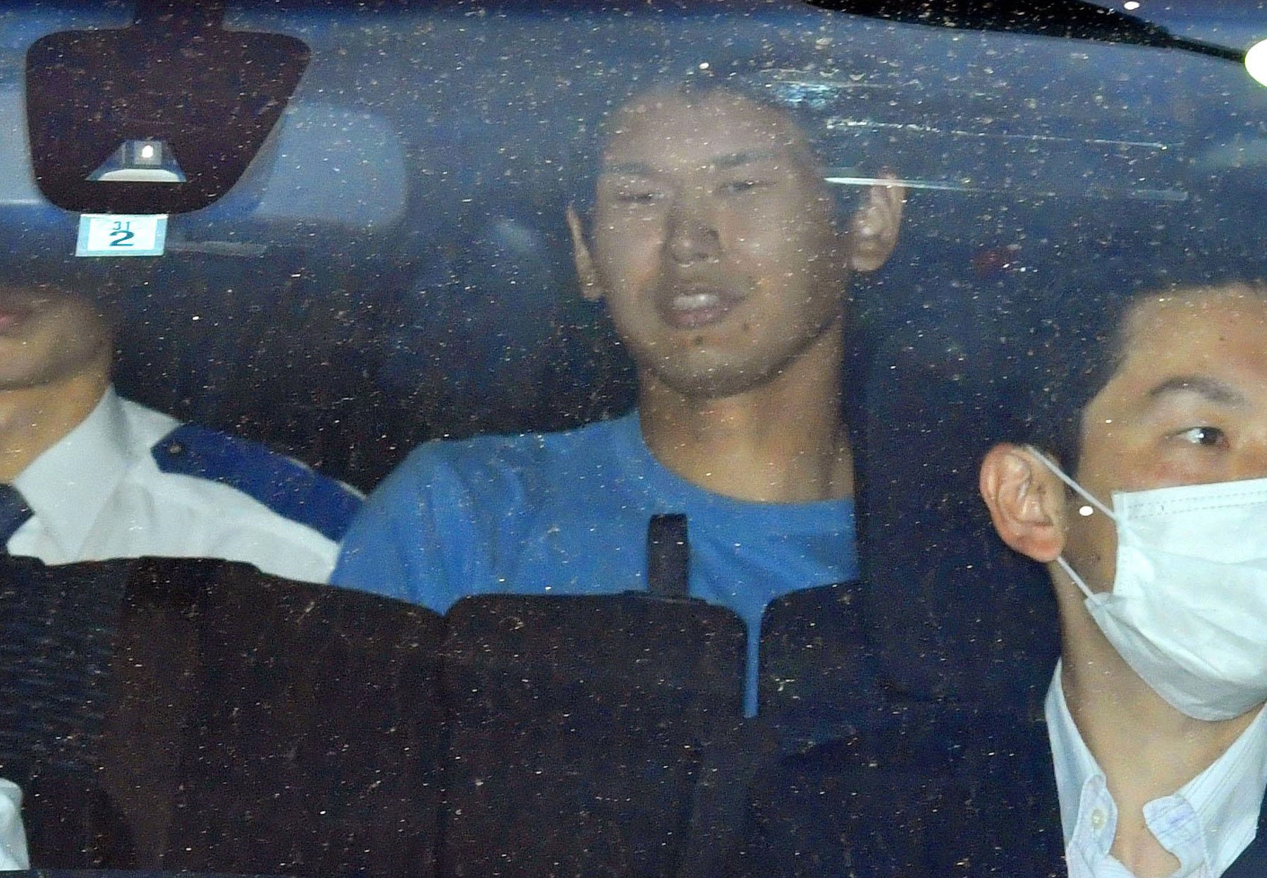 Tomohiro Iwazaki, arrested following Saturday's stabbing of singer Mayu Tomita, is transported from Koganei Police Station in western Tokyo on Monday. | KYODO