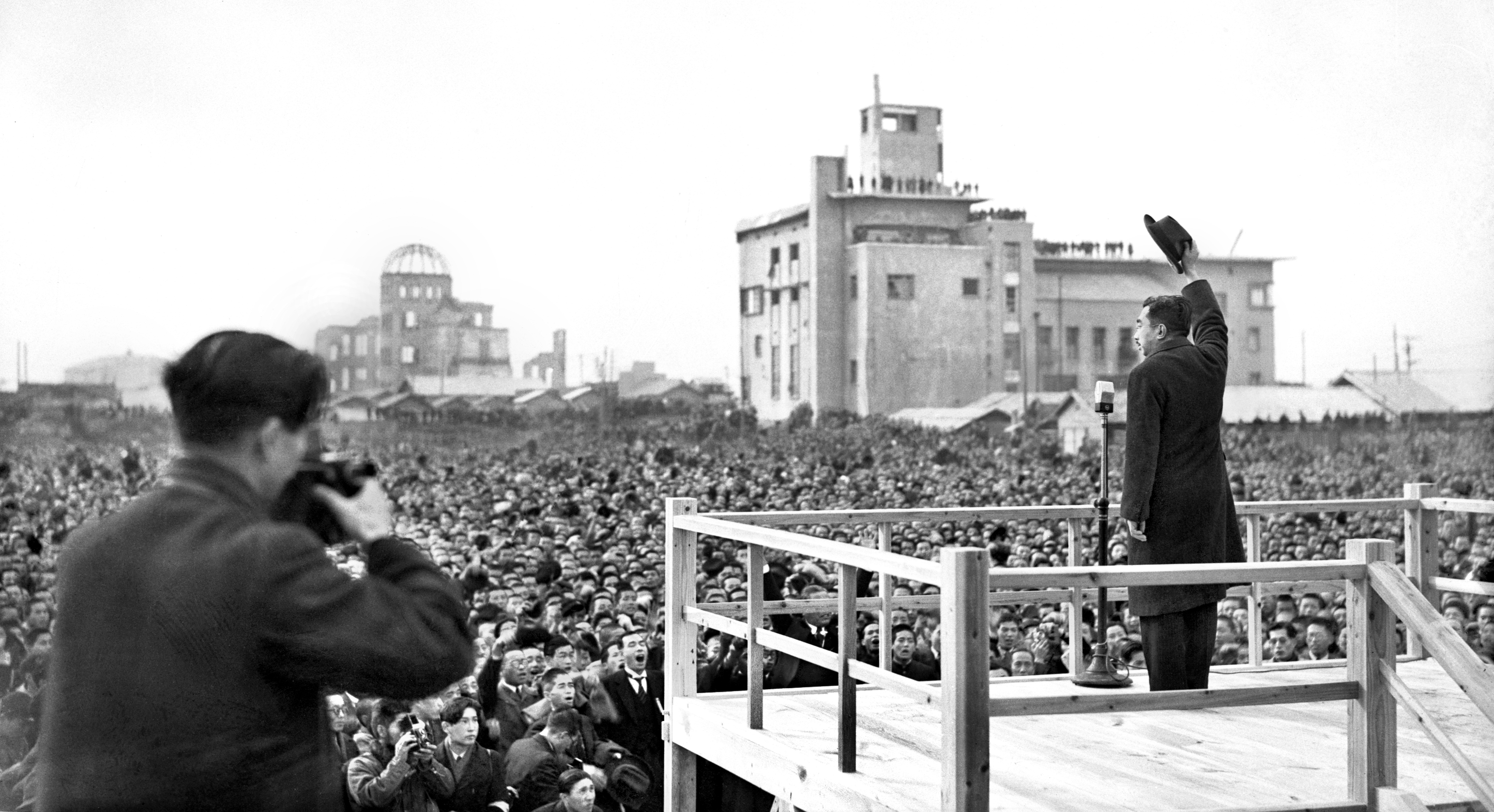 Emperor Hirohito, posthumously known as Emperor Showa, greets the crowd on Dec. 7, 1947, during his first visit to Hiroshima since the city was hit by an atomic bomb. As time heals the wounds of World War II, it has concealed many of the differences in opinion among survivors on both sides of the battle. | KYODO