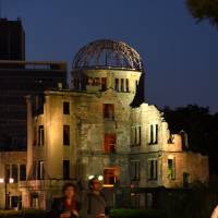 Tourists walk by the Atomic Bomb Dome, the most powerful symbol of the August 1945 atomic bombing of Hiroshima, on May 17. | SATOKO KAWASAKI