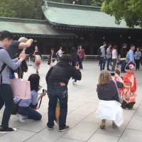 Tourists flock to a photo op at Meiji-Jingumae Shrine, one of the top destinations for overseas visitors to Tokyo.  | MIO YAMADA