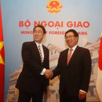 Foreign Minister Fumio Kishida meets with Vietnamese Deputy Prime Minister and Foreign Minister Pham Binh Minh during their talks in Hanoi on Thursday. | AFP-JIJI