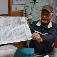 Cattle farmer Jiro Tochigi holds an autobiography penned by the grandmother of the current president of Wadakin, a restaurant in Mie Prefecture that specializes in serving Matsusaka beef. | J.J. O’DONOGHUE