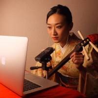 Sound of mind: Yukino Yumijuku, who runs the Japanese ASMR YouTube channel, plays shamisen for her online audience. | T. WADA