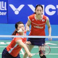 Ayaka Takahashi plays a shot as partner Misaki Matsumoto looks on during the women\'s doubles final at the Asian Championships on Sunday. | KYODO