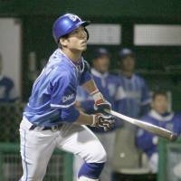 Yokohama\'s Masayuki Kuwahara hits a homer in the ninth inning of the BayStars\' 4-1 win over the Dragons on Wednesday. | KYODO