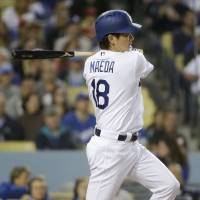 Dodgers starter Kenta Maeda hits an RBI single against the Angels during the second inning on Monday. Pujols, Trout ignite Angels as Maeda struggles again