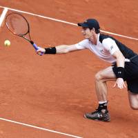 Andy Murray hits a return to Gilles Simon at the Madrid Masters on Thursday. Murray won in straight sets to reach the quarterfinals. Murray ousts Simon in Madrid
