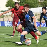 Japan\'s Takuma Asano (right) vies for the ball with Portugal\'s Diego Verdasca during Monday\'s match at the Toulon Tournament in Aubagne, France. Portugal beat Japan 1-0. | AFP-JIJI