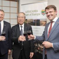 Vice Minister of the Economy of the Republic of Lithuania Marius Skarupskas (right), shares a toast with Lithuanian Ambassador to Japan Egidijus Meilunas (left) and Tatsumi Yamazaki (center), chairman of the Japan Bioindustry Association Steering Committee, at a welcome reception at the Lithuanian embassy on May 11. | YOSHIAKI MIURA