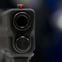 This file photo taken in 2014 shows a view down the barrel of a semi-automatic handgun displayed at the 43rd NRA Annual Meetings and Exhibits at the Indiana Convention Center in Indianapolis. Driven by fears of tighter regulation, gun sales in the United States have prospered during the Obama presidency and after mass killings, even as few new customers enter the market. The day after the massacre at an Orlando nightclub, investors were back betting on a pickup in gun sales Monday. | AFP-JIJI