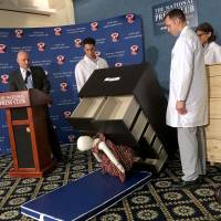 Elliot Kaye (left), chairman of the Consumer Product Safety Commission (CPSC) and CPSC employees watch as a 28-pound (13 kg) dummy falls over and under IKEA\'s Malm model chest of drawers, during a live demonstration at the National Press Club in Washington Tuesday. The furniture giant said it would recall its hugely popular MALM model of chest in the U.S. and Canada after six children in the U.S. were crushed to death when the chests tipped over. | AFP-JIJI