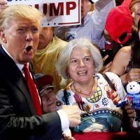 Republican U.S. presidential candidate Donald Trump greets people in the crowd at a campaign rally in Phoenix, Arizona, Saturday. | REUTERS