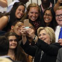 Democratic presidential candidate Hillary Clinton takes a photo with supporters after speaking about the economy Tuesday at Fort Hayes Vocational School in Columbus, Ohio. | AP
