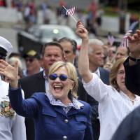 Democratic presidential candidate Hillary Clinton waves as she walks in a Memotial Day parade Monday in Chappaqua, New York. California Gov. Jerry Brown gives Clinton coveted nod as lead over surging Sanders slides