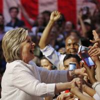 Hillary Clinton greets supporters Tuesday during her California primary night rally, held in New York\'s Brooklyn borough. | REUTERS
