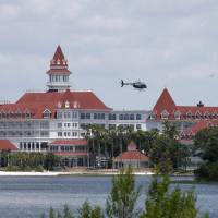 A Florida Fish and Wildlife Conservation Commission helicopter flies over the Seven Seas lagoon at Walt Disney World in Orlando on Wednesday during the search for Lane Graves. | REUTERS