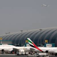 Aircraft are seen parked at a terminal at Dubai International Airport in the United Arab Emirates on May 10. The airport, the world\'s busiest for international travel, closed its airspace for 69 minutes on Saturday due to unauthorized drone activity nearby. | REUTERS