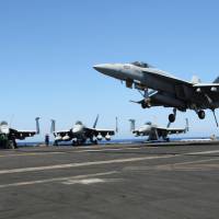 An F/A-18 fighter jet lands on the USS Harry S. Truman in the eastern Mediterranean Sea on June 6. | REUTERS