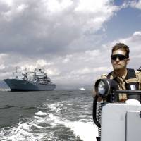 The NATO German warship FGS Bonn, part of the NATO flotilla patrolling the Aegean Sea to curb migrant activity between Turkey and Greece, is escorted by a rescue boat out of the Turkish harbor of Izmir. Once-wary EU and NATO to step up cooperation against threats from Russia, Islamic State