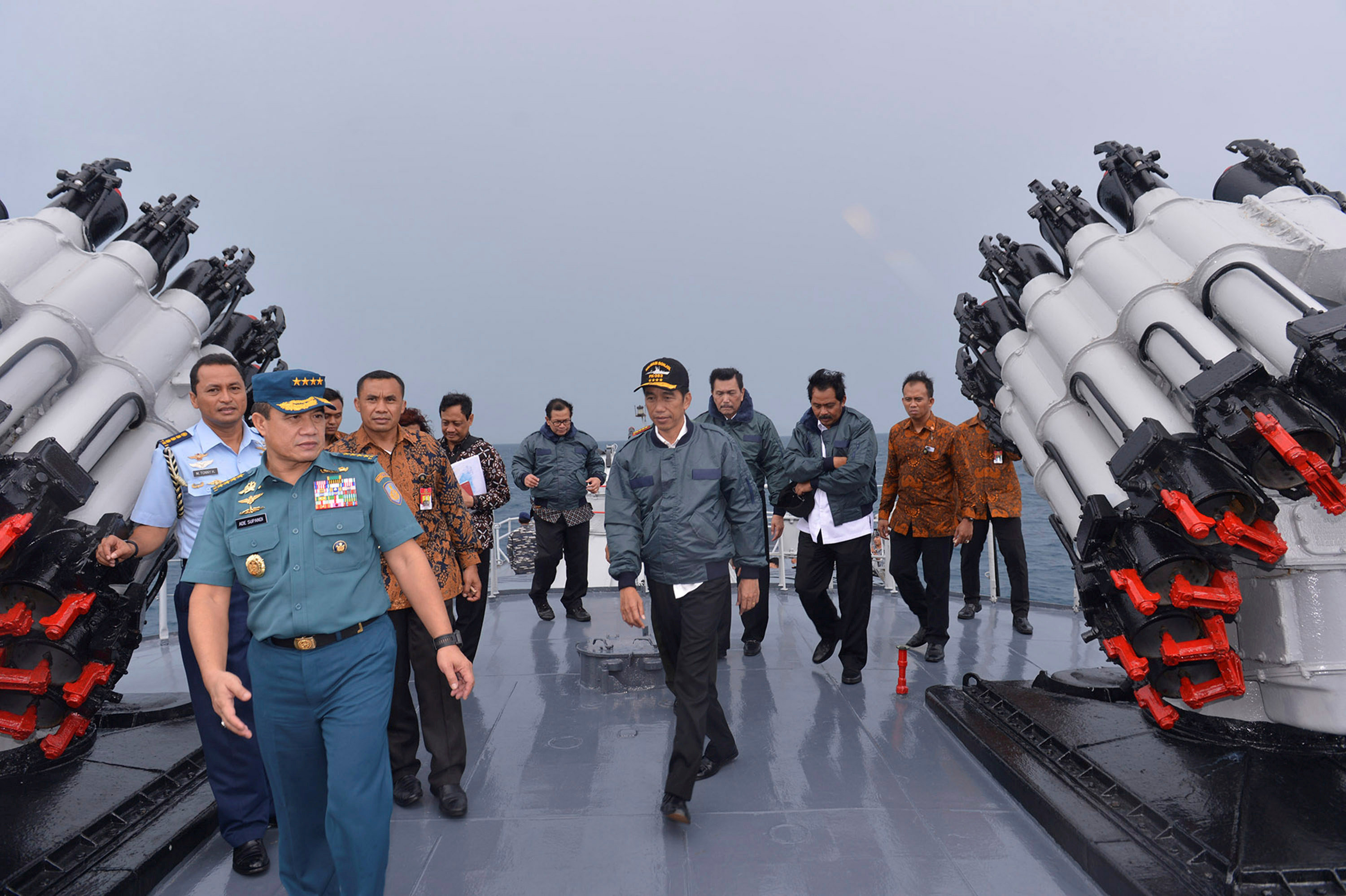 Indonesian President Joko Widodo walks on the deck of the Indonesian Navy ship KRI Imam Bonjol together with members of his Cabinet as the ship sails off the Natuna Islands in Riau Islands province on June 23. | REUTERS