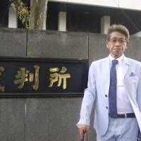 Masamitsu Yamamoto, a terminal cancer patient, leaves a Tokyo court building on June 6. | TOMOKO OTAKE
