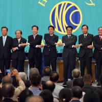 Leaders of political parties join hands before a policy debate at the Japan National Press Club in Tokyo on Tuesday, the day before the official start of campaigning for the July 10 Upper House election. | SATOKO KAWASAKI