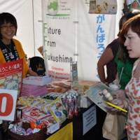Fukushima natives sell products made in the prefecture at the Japan Matsuri festival in London last September. | FUKUSHIMA MINPO