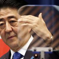 Prime Minister Shinzo Abe holds a news conference at his office in Tokyo on Wednesday. | AP