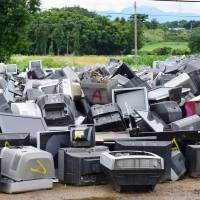 Television sets are piled up at a temporary storage site for earthquake debris in the city of Kumamoto\'s Higashi Ward Sunday. | KYODO