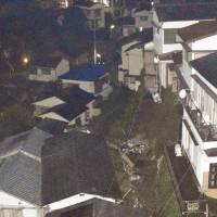 A landslide damaged five houses in Ofunagura in the city of Nagasaki Tuesday evening. | KYODO