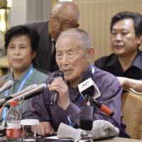 A former laborer addresses reporters in Beijing on Wednesday. Mitsubishi Materials settles with ex-slave laborers in China