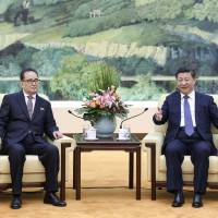 Chinese President Xi Jinping (right) meets with Ri Su Yong, one of North Korea\'s most prominent officials, in Beijing on Wednesday. | REUTERS