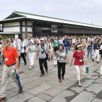 Tourists visit the Imperial Palace in central Tokyo on Saturday, as the Imperial Household Agency introduced a same-day registration system for guided tours of parts of the premises without prior reservation. | KYODO