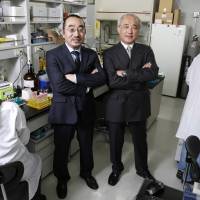 Hiroaki Suga (left), executive advisor, and CEO Kiichi Kubota of PeptiDream Inc. pose for a photo in the company\'s laboratory at the University of Tokyo in April. | BLOOMBERG
