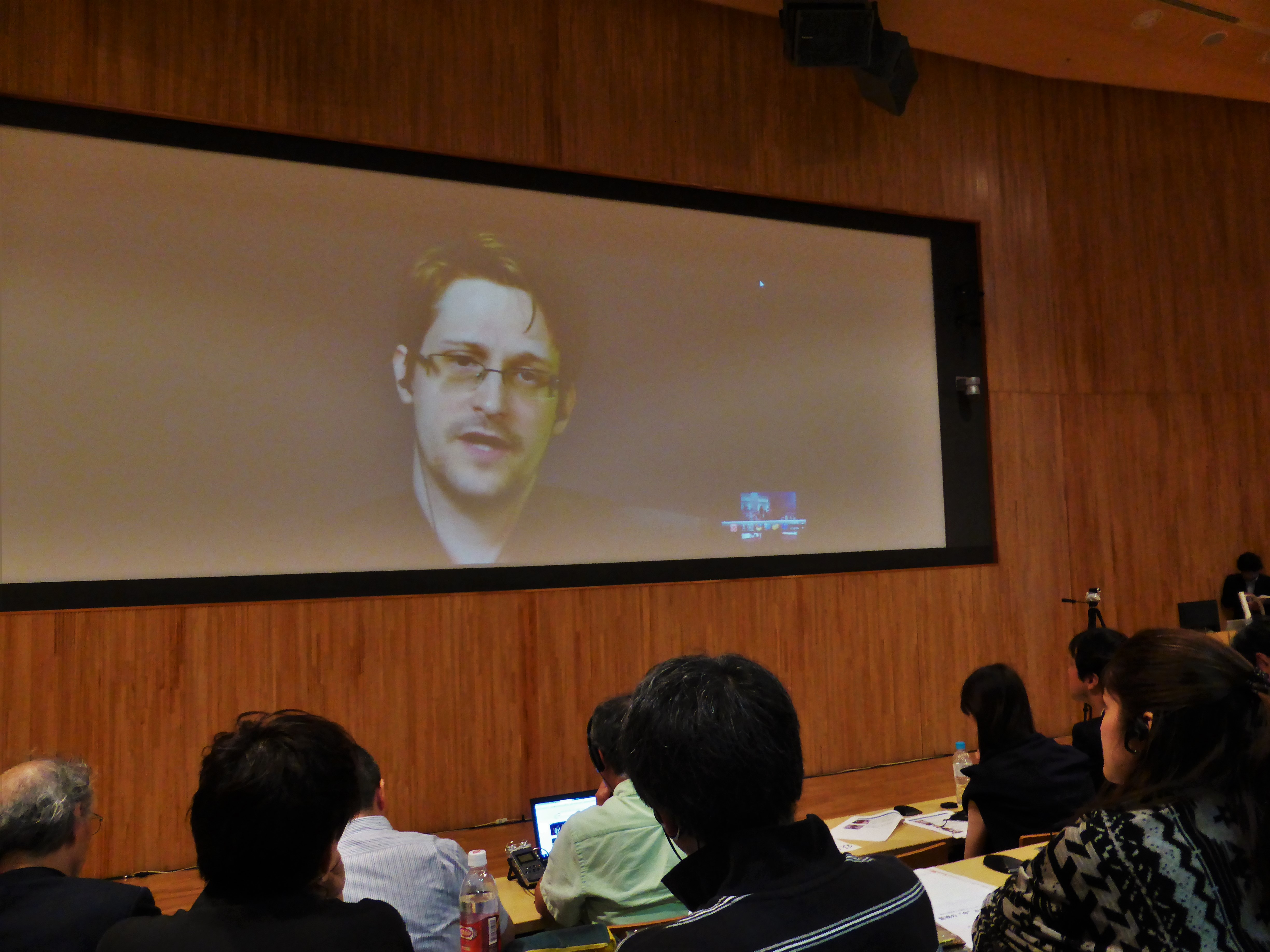 Edward Snowden, a former U.S. National Security Agency contractor who leaked secrets about the country's spying operations, speaks about U.S. surveillance activities in Japan via a video conference from Russia during a symposium in Tokyo on Saturday. | SHUSUKE MURAI
