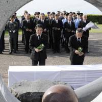 Shimabara Mayor Ryuzaburo Furukawa and families of the bereaved offer a silent prayer Friday to mark the 25th anniversary since a huge pyroclastic flow from Mount Unzen killed 43 people in Shimabara, Nagasaki Prefecture. | KYODO