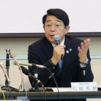 Hideki Matsuzaki, mayor of Urayasu, Chiba Prefecture, speaks at a press conference Thursday in Urayasu, as Iwao Kikuchi, senior associate professor of the Juntendo University Urayasu Hospital, looks on. | KYODO