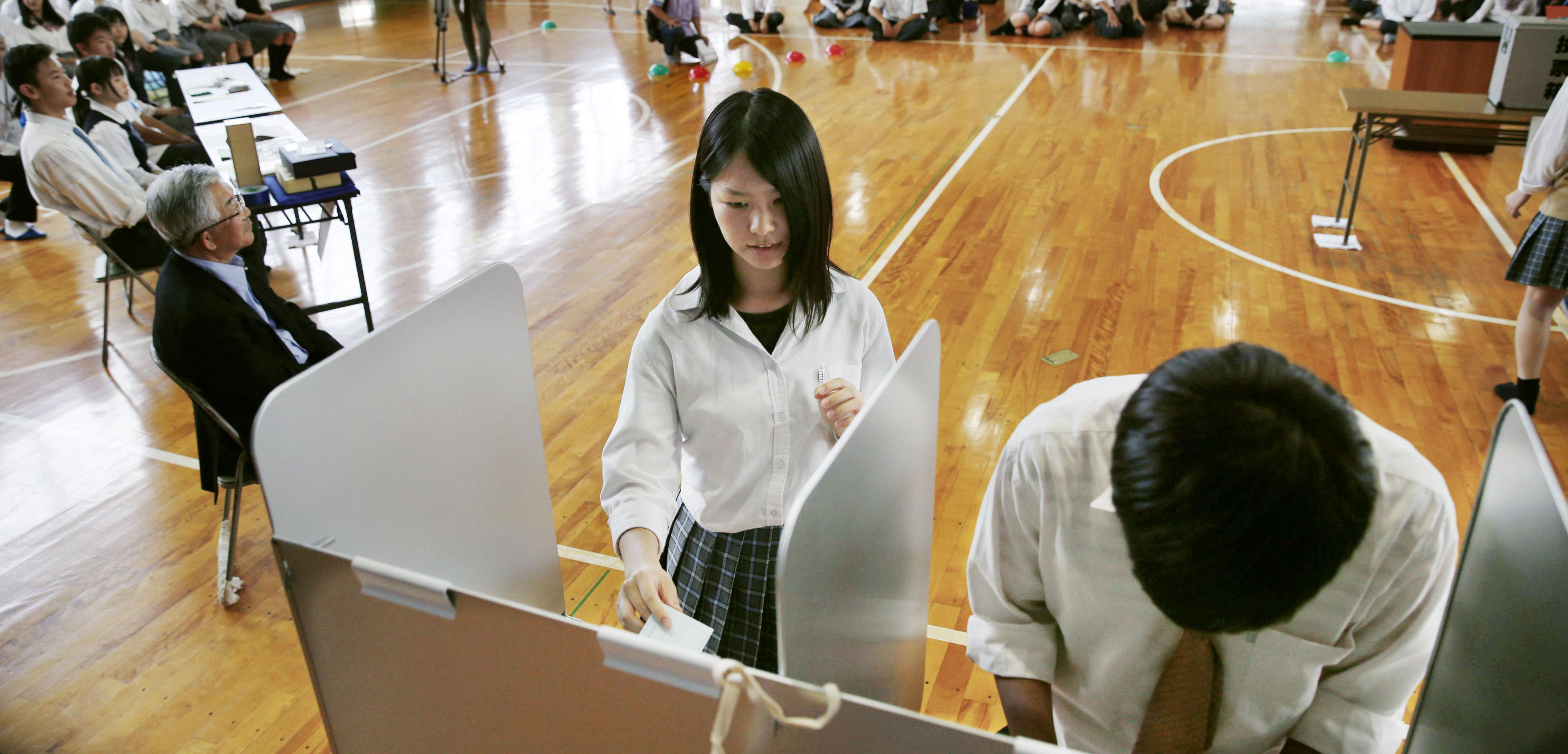 High school students practice voting on June 15 in Hino, Shiga Prefecture, which will hold a mayoral election on July 3. | KYODO