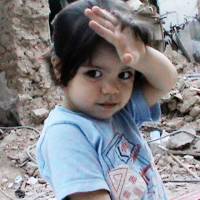 A child wanders in the rubble of Homs, Syria, in Ossama Mohammed and Wiam Simav Bedirxan’s “Silvered Water, Syria Self-Portrait,” which is being released in Japan as “Syria Mon Amour.” | © 2014 — LES FILMS D’ICI — PROACTION FILM