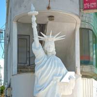 Liberty, imported: A miniaturized Statue of Liberty stands outside an apartment block along Route 58.  | STEPHEN MANSFIELD