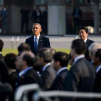 Lagging behind?: U.S. President Barack Obama and Prime Minister Shinzo Abe arrive at Hiroshima Peace Memorial Park in Hiroshima on Friday, May 27. Hosting the G-7 summit in May was supposed to be an opportunity for Abe to strut tall on the international stage, rubbing shoulders with the heads of state that represent the rich nations, but things didn\'t really go to plan. | BLOOMBERG