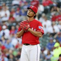 Texas pitcher Yu Darvish will not start Monday\'s game against the A\'s because of tightness in his shoulder and neck. | USA TODAY / REUTERS