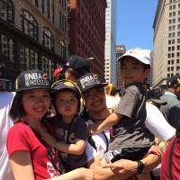 Cavaliers athletic trainer/performance scientist Yusuke Nakayama participates in the team\'s championship parade with his family in Cleveland on Wednesday. | YUSUKE NAKAYAMA