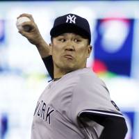New York’s Masahiro Tanaka delivers during the Yankees’ 8-2 win over the Twins on Friday. Tanaka stymies Twins