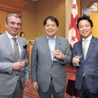 Georgian Ambassador Levan Tsintsadze (left) shares a drink with former Agriculture, Forestry and Fisheries Minister Yoshimasa Hayashi (center) and Parliamentary Vice-Minister for Foreign Affairs Masakazu Hamachi during a reception to celebrate the country\'s Independence Day at the Hotel Okura Tokyo on May 26. | YOSHIAKI MIURA