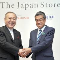 Isetan Mitsukoshi Holdings Ltd. President and CEO Hiroshi Ohnishi (right), shakes hands with Cool Japan Fund CEO Nobuyuki Ota during a press conference for a Cool Japan Project, \"ISETAN The Japan Store Kuala Lumpur &amp; The Japan Store ISETAN MITSUKOSHI Paris,\" at the Tsunamachi Mitsui Club in Tokyo on June 7. | YOSHIAKI MIURA