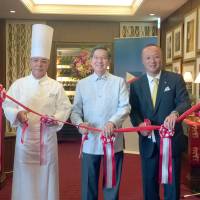 Philippine Ambassador Manuel M. Lopez (center) joins Grand Chef of the Imperial Hotel Kenichiro Tanaka (left) and Imperial Hotel President and General Manager Hideya Sadayasu at a ribbon-cutting ceremony for the \"Philippine Fiesta\" dining promotion, which runs through June 19 at the Imperial Viking Sal restaurant, at the Imperial Hotel, Tokyo, on June 13. | HIROKO INOUE