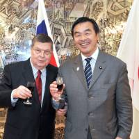 Russian Ambassador Evgeny Afanasiev (left) poses with Minister of Education, Culture, Sports, Science and Technology Hiroshi Hase at a reception celebrating the Day of Russia at the embassy in Tokyo on June 10. | YOSHIAKI MIURA