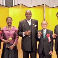 Cameroon Ambassador Pierre Ndzengue (center) prepares to make a toast with (from left) Asahiko Mihara, member of the House of Representatives; the ambassador\'s wife Alphonsine; Yasumu Sakamoto, former Nakatsue mayor and present director of the Nakatsue Village Earth Foundation; and State Minister for Financial Affairs Manabu Sakai at a reception to celebrate the country\'s 44th National Day at the Marriott Hotel in Tokyo on June 20. | YOSHIAKI MIURA