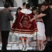 Hail the new queen: Mayu Watanabe, a member of Japans all-girl pop idol group AKB48 members, shows off the winner\'s cape after taking the No. 1 spot of the AKB48\'s General Election 2014 in Tokyo, on, June 7. | REUTERS
